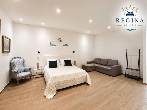 a bedroom with a king sized bed and a couch at Regina Suite Mazara in Mazara del Vallo