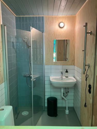 a bathroom with a sink and a shower at The forest in Sjöbo
