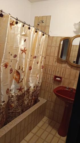 a bathroom with a shower curtain and a sink at la casona de yala in Yala