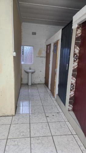 an empty hallway with a sink in a room at S-and Kasa Guest House in Pietermaritzburg