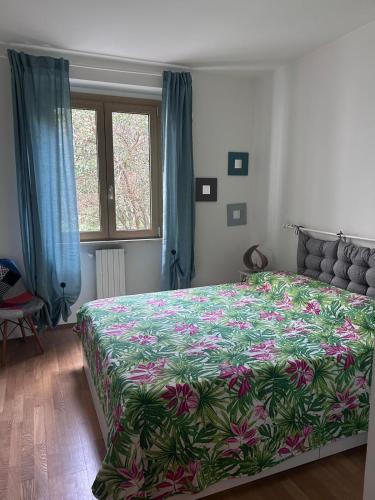 a bedroom with a large bed with a floral bedspread at Verde Lido in Livorno