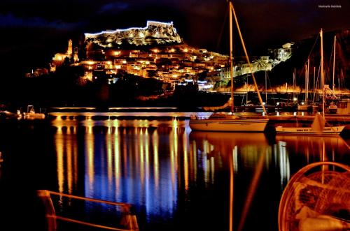 a view of a harbor at night with boats in the water at Hotel Meli in Castelsardo