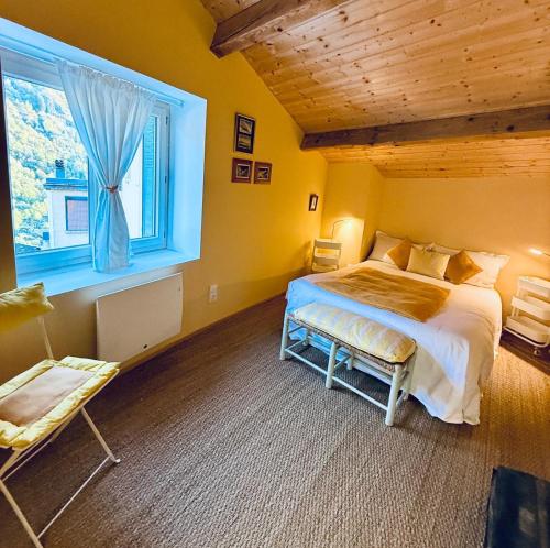 a bedroom with a large bed and a window at ValTho Orelle Le Paradis Blanc in Orelle
