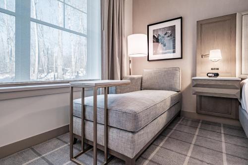 a hotel room with a chair and a window at Hotel Bridgton in Bridgton
