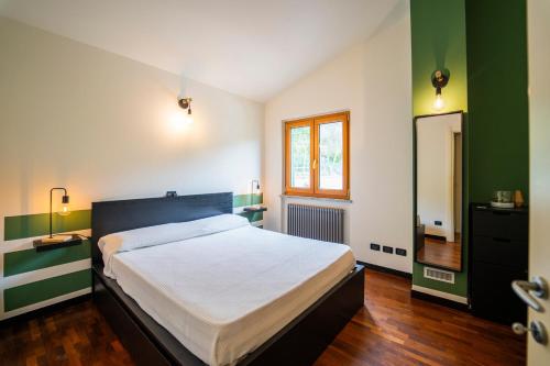 a bedroom with a large bed and a window at Villa Lepre in Casarza Ligure