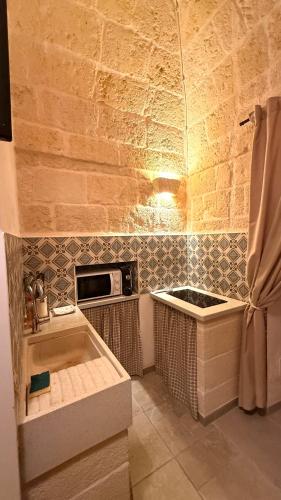 a kitchen with a sink and a stove at Luxury Vittoria in Ceglie Messapica