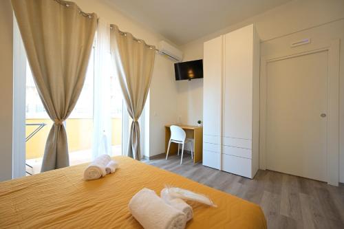 a bedroom with a bed with towels on it at Arabia Suites in Cosenza