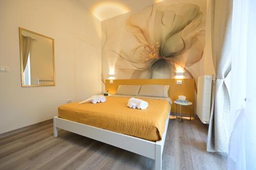a bedroom with a bed with two towels on it at Arabia Suites in Cosenza