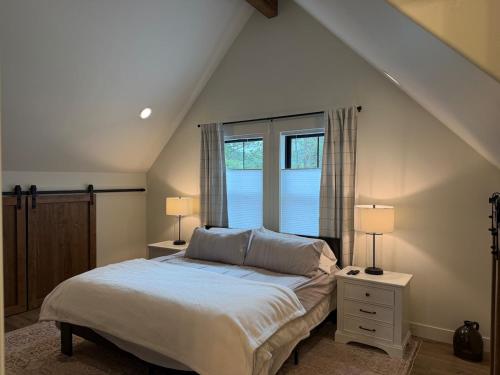 a bedroom with a bed with two lamps and a window at Hungry Horse Farmhouse in Hungry Horse