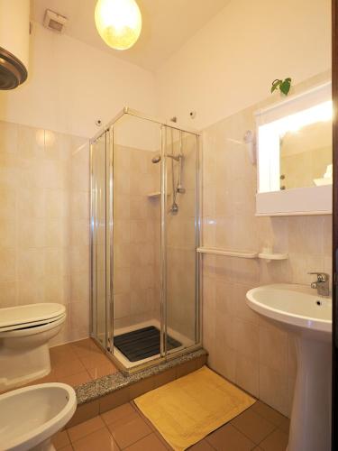 a bathroom with a shower and a toilet and a sink at Camere Santa Margherita in Santa Margherita-Sant'Alessio Siculo