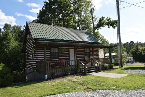 a small log cabin with a porch at Laurel Lake Cabins in Corbin