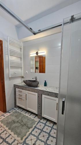 a bathroom with a sink and a mirror at Summerstone Cottage in Aliveri