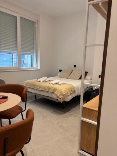 a bedroom with a bed and a mirror at La Encina Suites in Salamanca