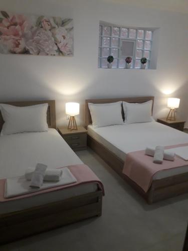 two beds in a room with two lamps at VILLA stamatia - lena in Limenaria