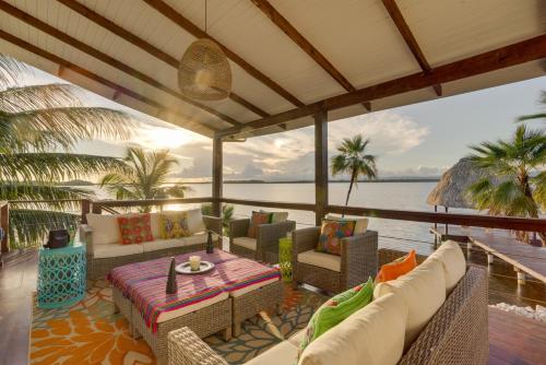 a patio with a table and chairs and the water at Luxury Waterfront 3bd Villa w Pool Dock in Maya Beach