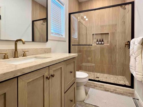 a bathroom with a shower and a toilet and a sink at Orion A 3BR Heated Pool with Desk and Laundry in Port Isabel