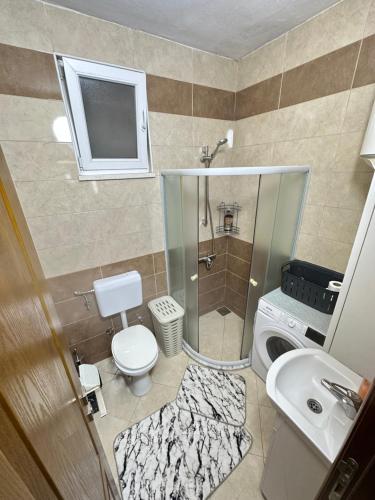 a small bathroom with a toilet and a sink at White Hill in Ulcinj