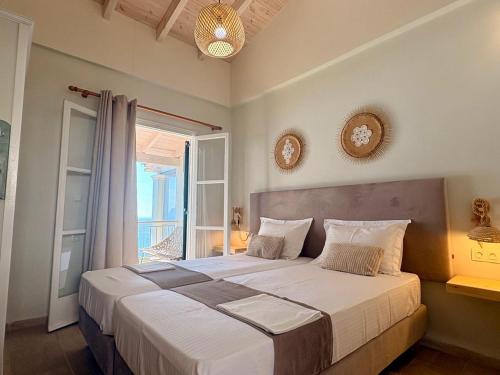 a bedroom with a large bed and a window at Vicky's Panoramic View Apartments in Pelekas