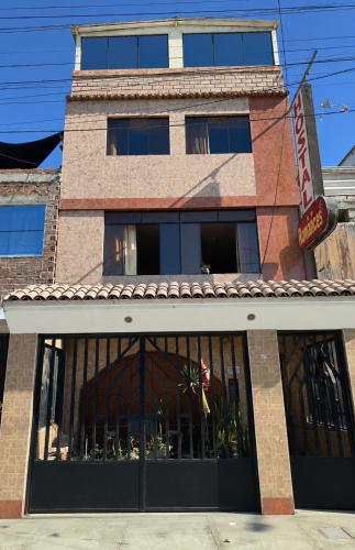 a building with a sign in front of it at Hostal Romances in Chimbote