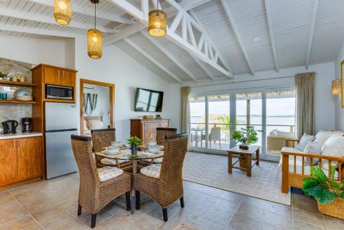 a kitchen and living room with a table and chairs at Luxurious Lagoon Home w Elegant Decor & Pool in Maya Beach