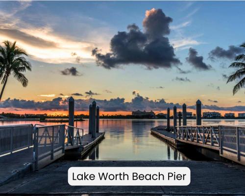 a dock with a sunset over a body of water at Lucerne Collection Private 4-Unit Building in Lake Worth