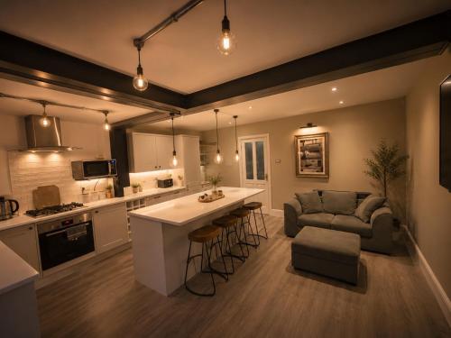 a kitchen and living room with a couch and a table at Williamson House Lancaster in Lancaster
