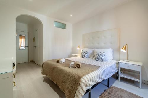 a bedroom with a bed with two stuffed animals on it at Suites By The River in Ferragudo