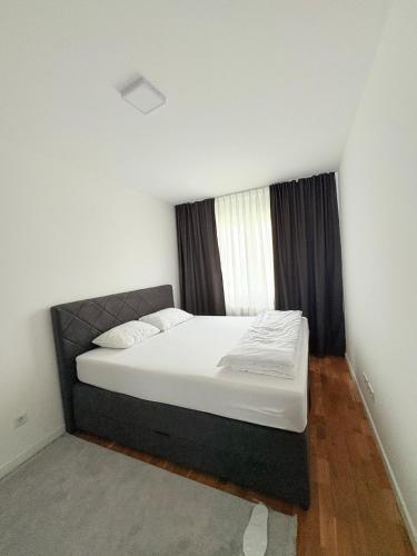 a bedroom with a large bed with a window at Sky apartment in Sarajevo