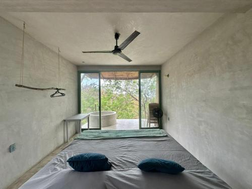 a bedroom with a bed with two pillows on it at Casa Lai in Mazunte