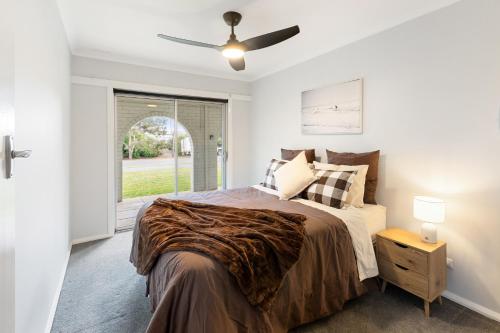 a bedroom with a bed and a ceiling fan at Kidston Arches - HotTub - 2 Min Walk to Golf Course in Mansfield