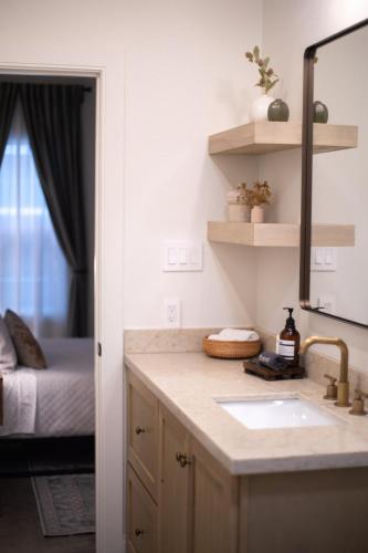 a bathroom with a sink and a mirror and a bed at Orion B, Vaulted Ceilings, Pool, Bunk Room in Port Isabel