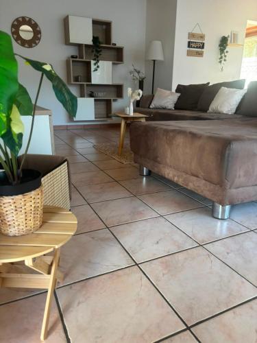 a living room with a couch and a tile floor at Angolo del Tramonto in Gambarogno