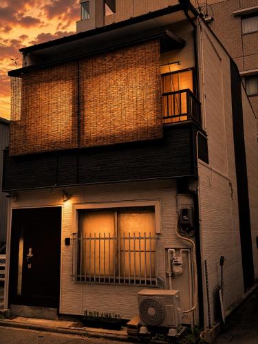 an apartment building with a door and a balcony at 将軍町家 in Nagoya