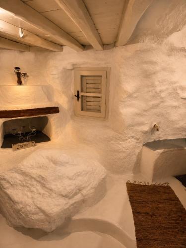 a white bathroom with two sinks and a window at Artemis Cottage Authentic Mykonian Stone House near Super Paradise in Super Paradise Beach