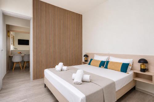 a bedroom with a large bed with towels on it at Sole e Mare B1 Beachfront Sea View Apartment in Koutsourás