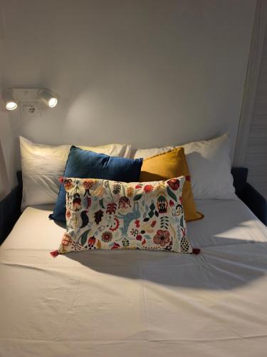 a bed with several pillows on top of it at fairytale home - panorama in Agropoli
