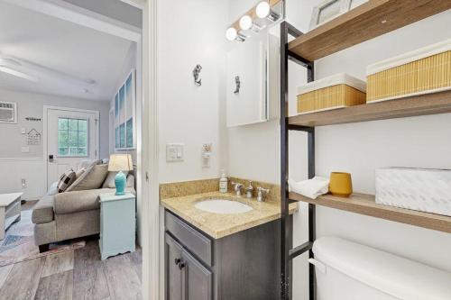 a bathroom with a sink and a toilet and a couch at Selkie Village in Wells