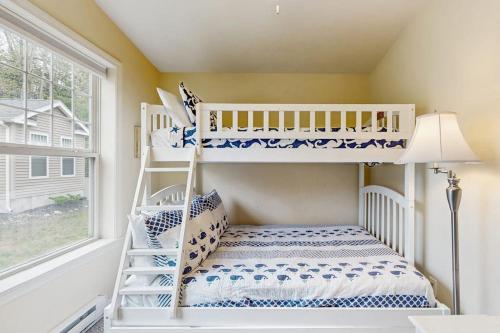 a white bunk bed in a room with a window at Selkie Village in Wells