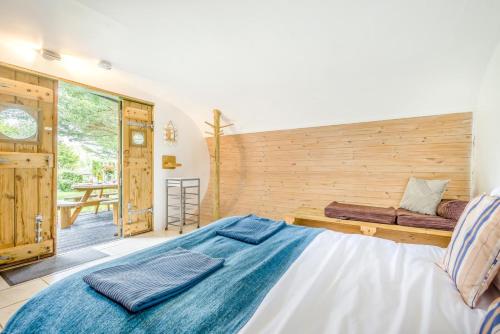 a bedroom with a bed and a wooden wall at 1 Bed in Bude oc-s34857 in Bude