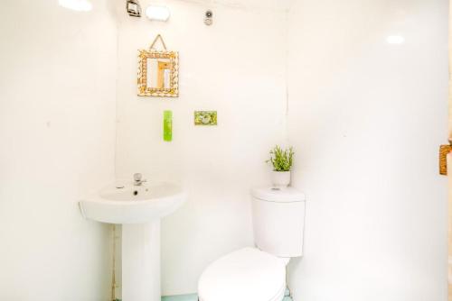 a white bathroom with a toilet and a sink at 1 Bed in Bude oc-s34855 in Bude