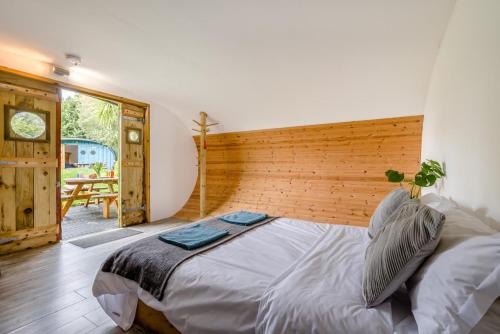 a bedroom with a large bed with a wooden headboard at 1 Bed in Bude oc-s34853 in Bude