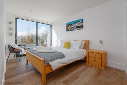 a bedroom with a bed and a large window at Little Spinney in Dorchester