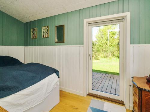 a bedroom with a bed and a door to a patio at 4 star holiday home in Slagelse in Slagelse