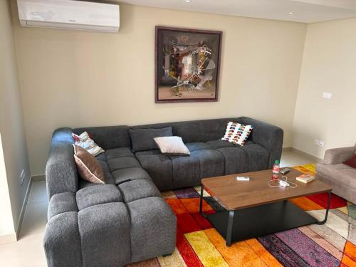 a living room with a couch and a coffee table at Waterfront - B luxury in Dakar