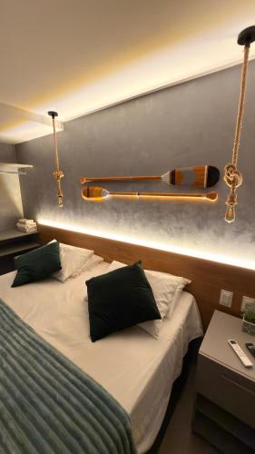 a hotel room with two beds and a lamp at Flat no Coração do Cabo Branco in João Pessoa