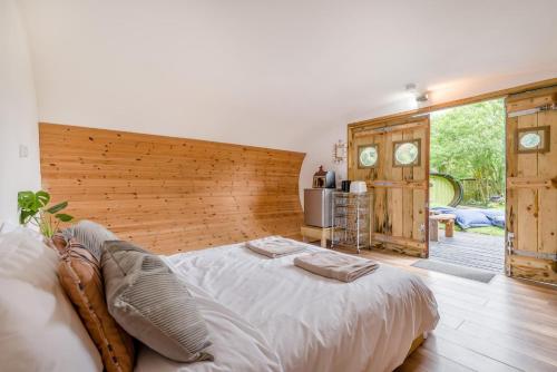 a bedroom with a large bed with a wooden headboard at 1 Bed in Bude oc-s34851 in Bude