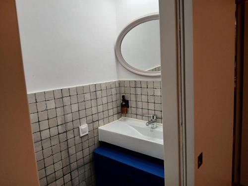 a bathroom with a white sink and a mirror at Apartaments "Casa Melé" 2 in Lleida