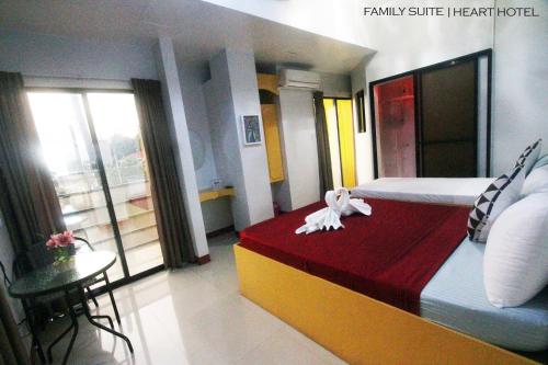 a bedroom with a bed with a stuffed animal on it at Heart Hotel and Services in Dumaguete