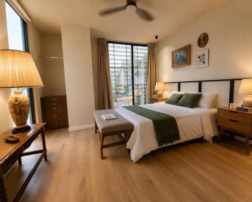 a bedroom with a large bed and a window at DreamHaus Suites - Country Club Guadalajara in Guadalajara