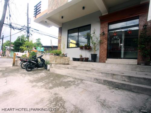 a motorcycle parked in front of a building at Heart Hotel and Services in Dumaguete